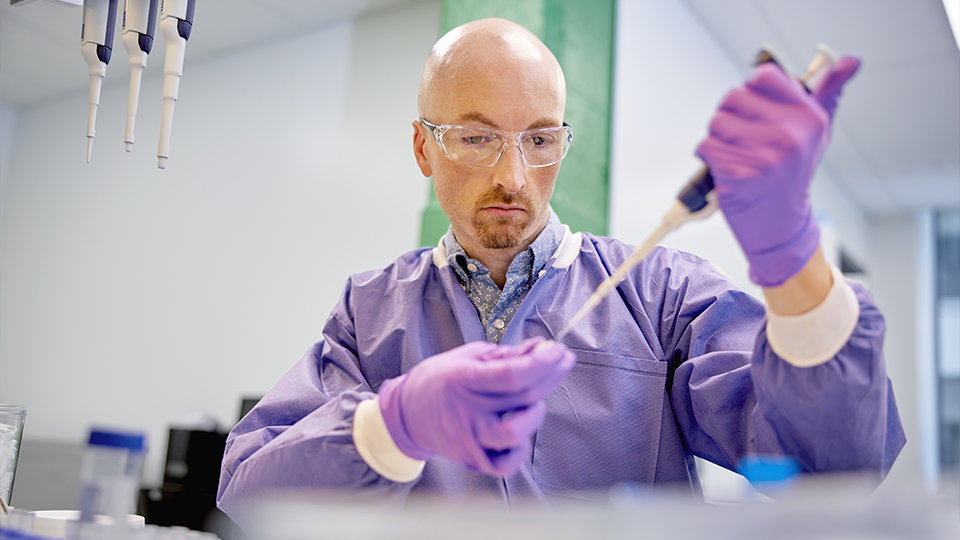 A scientist works in the lab.